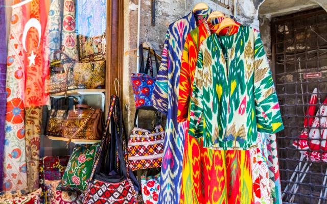 The Hidden Arasta Bazaar right Beside the Blue Mosque in Istanbul featuring very colorful clothing and gifts.