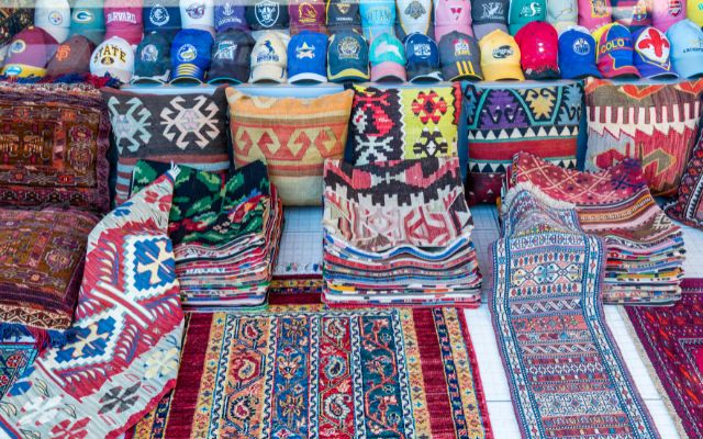 Arasta Bazaar Carpet Shop with loads of colorful carpets and kilms out front