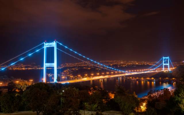 Istanbul bridges featuring the Fatih Sultan Mehmet Bridge at night all lit up